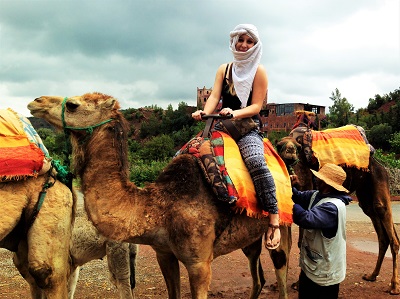 Smiling girl on camel in Marrakech