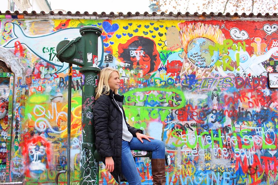 Girl in front of graffiti wall