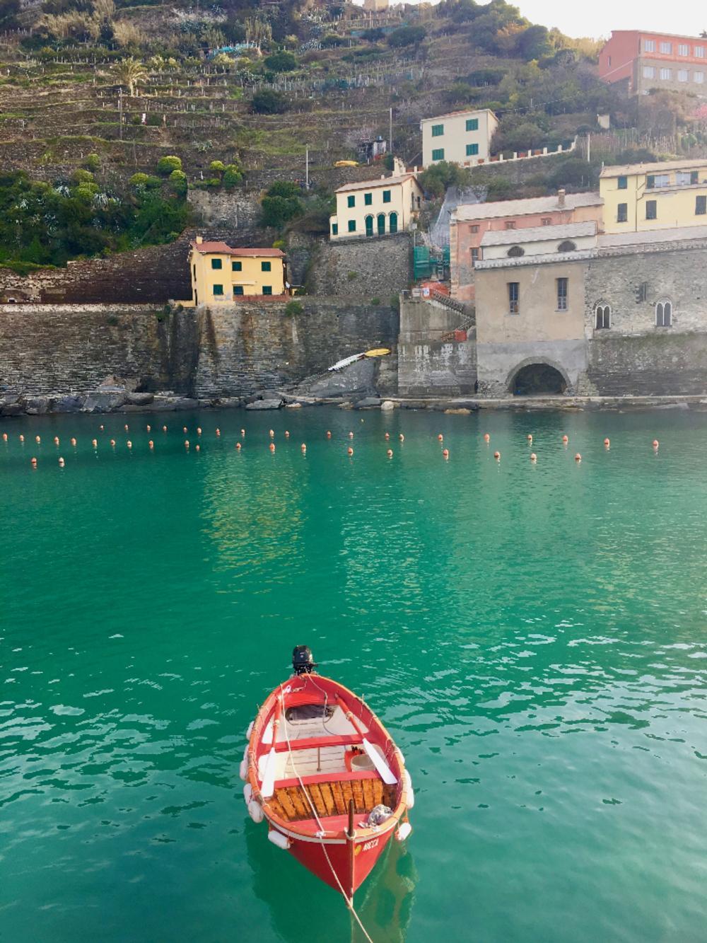 Red boat in sea in Cinque Terre