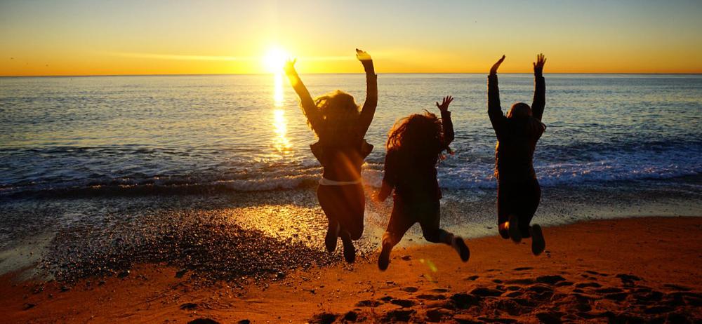 Students jumping on Spanish beach at sunrise by Abigail Glaessner