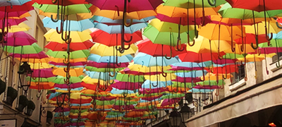 Umbrellas over French sidewalk