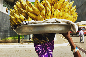 woman carrying bananas on head