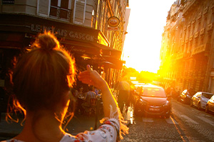 Student peering into the sun  on a French street
