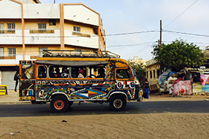 Senegalese bus driving down street