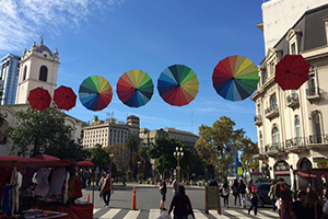 Rainbow wheel decorations over a street crossing