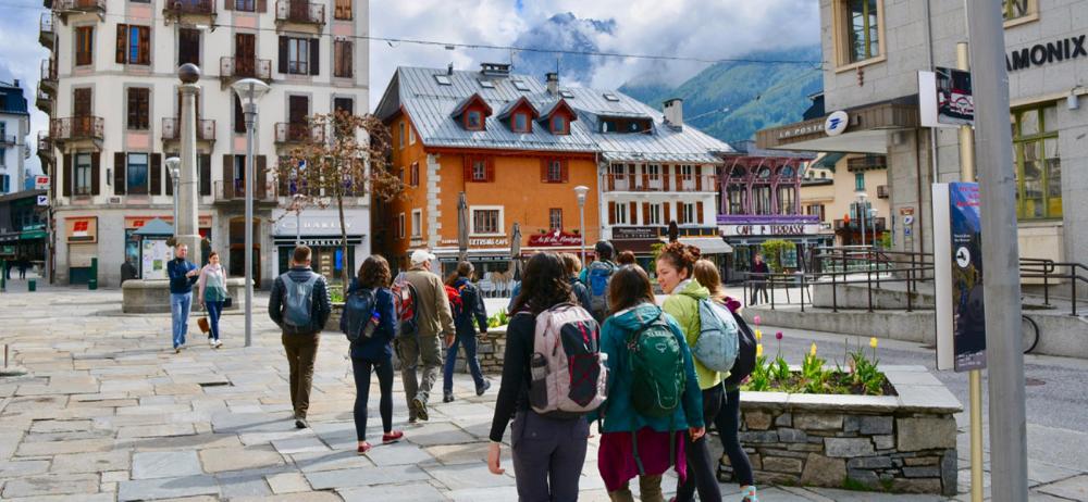 Students walking through a quaint French square by Chad Endicott