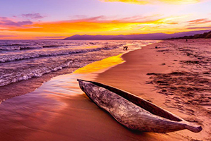 Canoe on the beach at sunset in Malawi