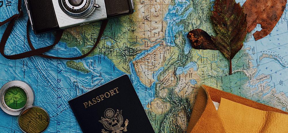 passport & camera on a map
