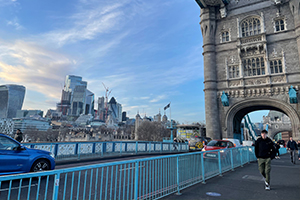 Student walking down bridge in London